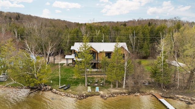 835 M-88, Bellaire, MI 49615 - view from above of property with a heavily wooded area and a nearby body of water