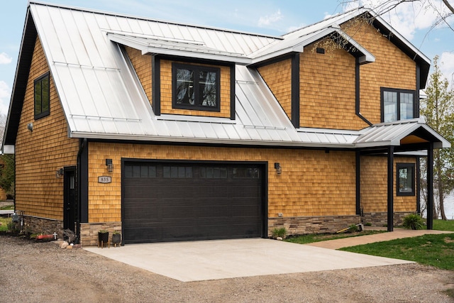 835 M-88, Bellaire, MI 49615 - modern farmhouse featuring a standing seam roof, concrete driveway, and a garage
