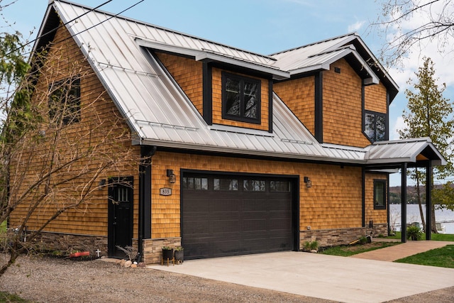 835 M-88, Bellaire, MI 49615 - view of front of property featuring a garage, driveway, a standing seam roof, and metal roof
