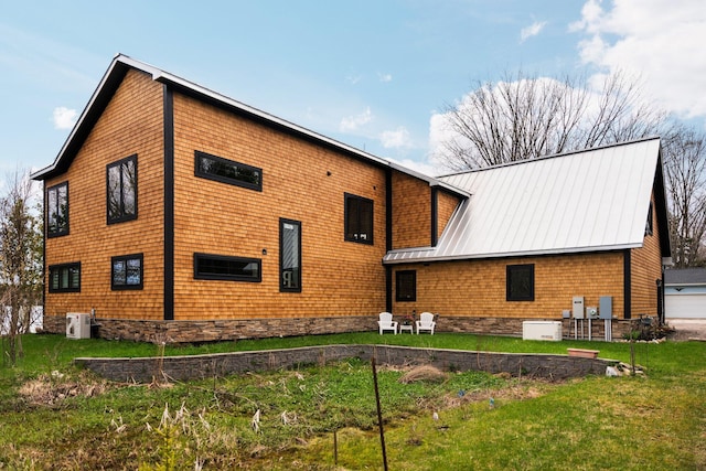 835 M-88, Bellaire, MI 49615 - view of side of home featuring ac unit, metal roof, and a lawn