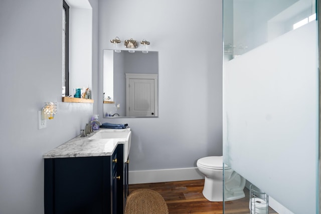 835 M-88, Bellaire, MI 49615 - bathroom with wood finished floors, vanity, toilet, and baseboards