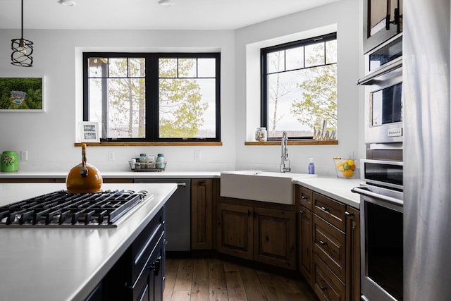 835 M-88, Bellaire, MI 49615 - kitchen with a sink, light countertops, stainless steel appliances, dark wood-style flooring, and recessed lighting