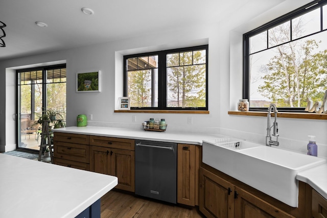 835 M-88, Bellaire, MI 49615 - kitchen featuring a sink, stainless steel dishwasher, light countertops, and dark wood-type flooring