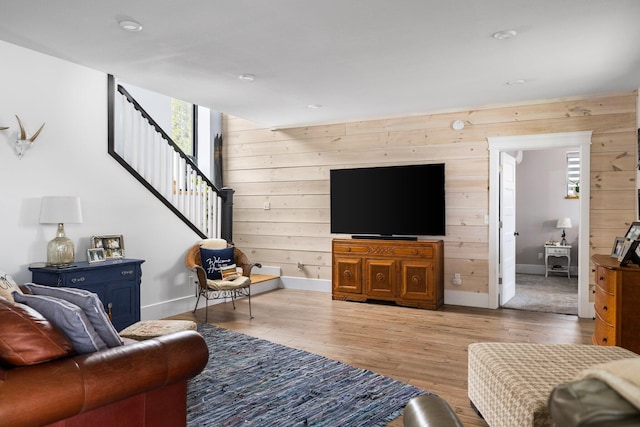 835 M-88, Bellaire, MI 49615 - living area featuring wooden walls, stairs, wood finished floors, baseboards, and recessed lighting