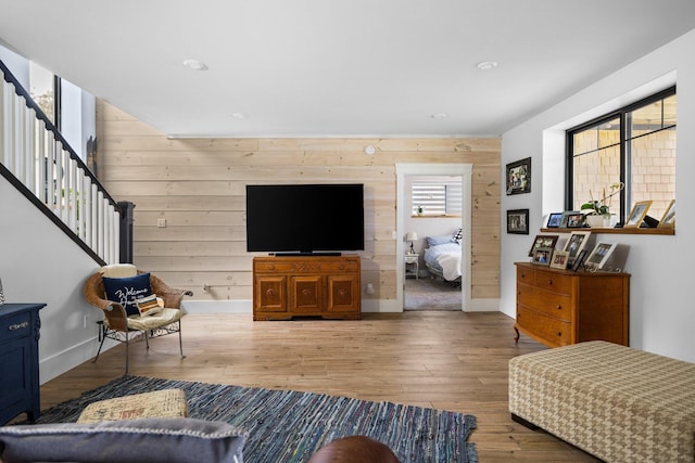 835 M-88, Bellaire, MI 49615 - living room with wood walls, hardwood / wood-style flooring, baseboards, and stairway