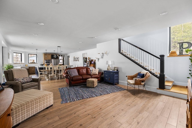 835 M-88, Bellaire, MI 49615 - living area featuring stairs, light wood-style floors, baseboards, and recessed lighting