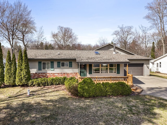 single story home with a shingled roof, brick siding, a garage, a porch, and concrete driveway