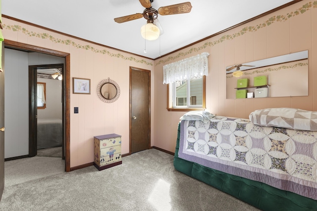 bedroom featuring crown molding, a closet, baseboards, ceiling fan, and light colored carpet