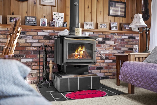 details featuring a wood stove, wooden walls, and carpet flooring