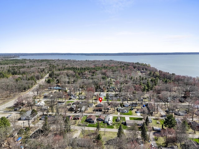 birds eye view of property with a residential view, a water view, and a wooded view