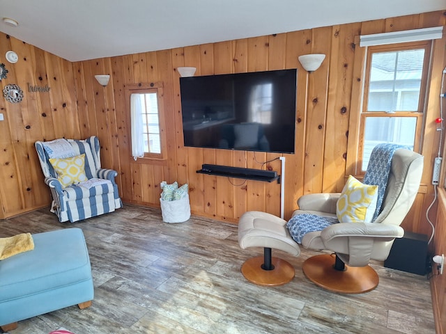 living area featuring wood finished floors and wooden walls
