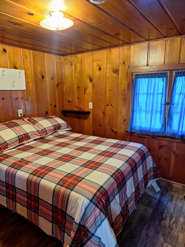 bedroom featuring wooden walls and wood finished floors