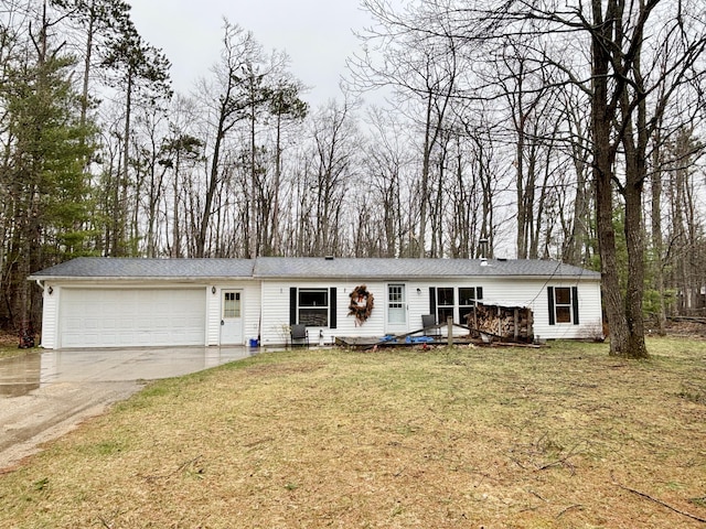 3313 Pleasant View Dr, Lewiston, MI 49756 - view of front facade with driveway, a garage, a front lawn, and a deck
