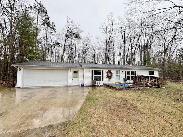 3313 Pleasant View Dr, Lewiston, MI 49756 - view of front facade with driveway, a garage, a front lawn, and a deck