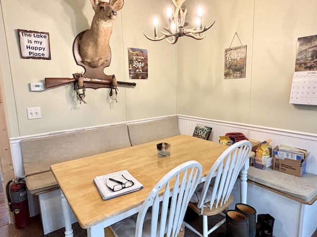 3313 Pleasant View Dr, Lewiston, MI 49756 - dining room featuring a chandelier and wainscoting