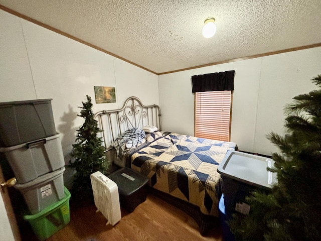 3313 Pleasant View Dr, Lewiston, MI 49756 - bedroom featuring crown molding, lofted ceiling, wood finished floors, and a textured ceiling