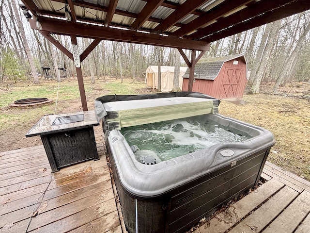 3313 Pleasant View Dr, Lewiston, MI 49756 - wooden terrace featuring a hot tub, a shed, an outdoor fire pit, and a wooded view