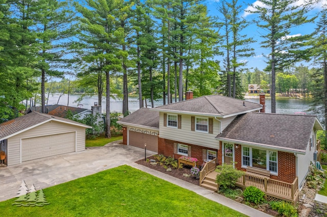3897 S Mielke Way Rd, Lewiston, MI 49756 - tri-level home featuring a water view, a front lawn, and brick siding