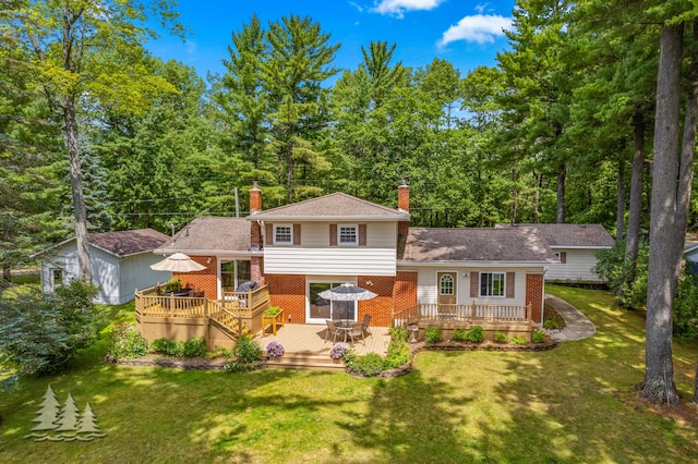 3897 S Mielke Way Rd, Lewiston, MI 49756 - rear view of property with a lawn, brick siding, a chimney, and a wooden deck