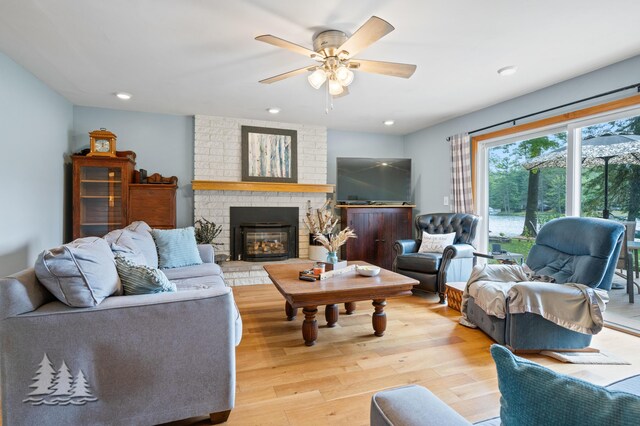 3897 S Mielke Way Rd, Lewiston, MI 49756 - living room featuring light wood-type flooring, recessed lighting, ceiling fan, and a fireplace