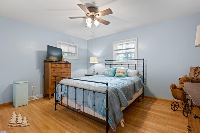 3897 S Mielke Way Rd, Lewiston, MI 49756 - bedroom featuring a ceiling fan, baseboards, and light wood-style floors