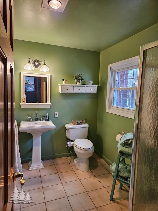 3897 S Mielke Way Rd, Lewiston, MI 49756 - bathroom with baseboards, tile patterned floors, and toilet