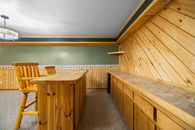 1350 Pine Point Dr, Lewiston, MI 49756 - bar area featuring wooden walls, wainscoting, and hanging light fixtures