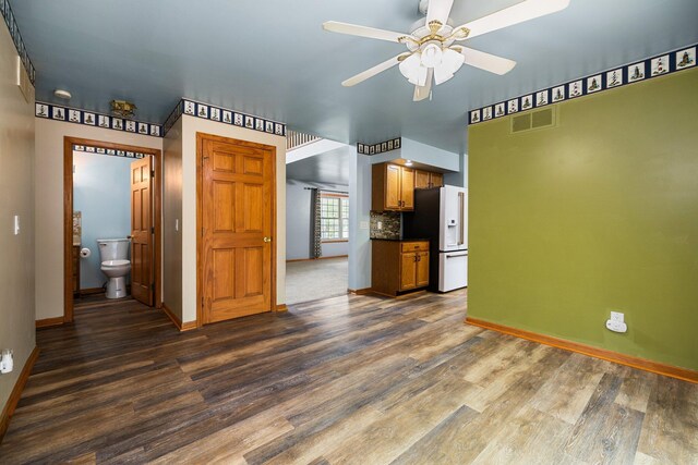 1350 Pine Point Dr, Lewiston, MI 49756 - unfurnished living room with baseboards, dark wood-style floors, and a ceiling fan