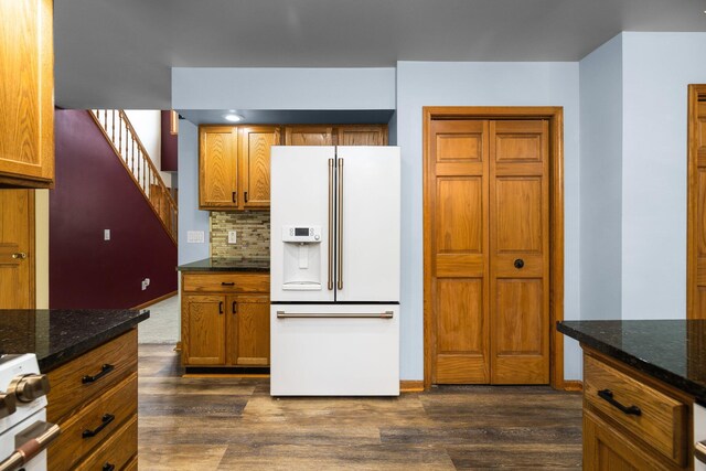 1350 Pine Point Dr, Lewiston, MI 49756 - kitchen with white appliances, dark wood-style flooring, decorative backsplash, and dark stone countertops