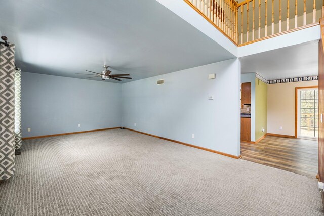 1350 Pine Point Dr, Lewiston, MI 49756 - unfurnished living room with ceiling fan, carpet flooring, and baseboards
