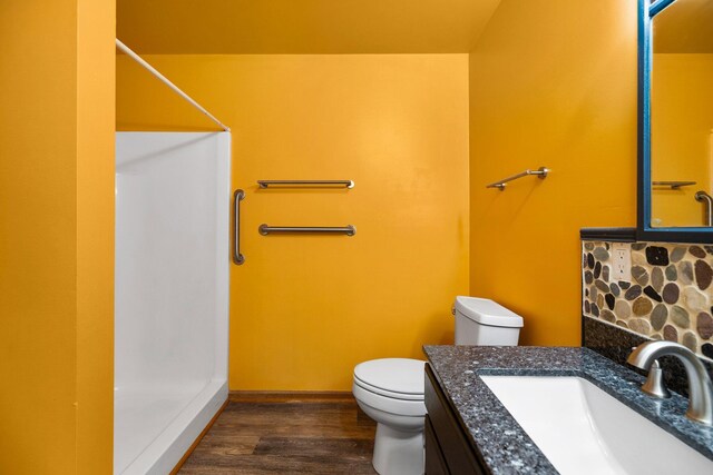 1350 Pine Point Dr, Lewiston, MI 49756 - full bathroom with toilet, a shower, vanity, and wood finished floors