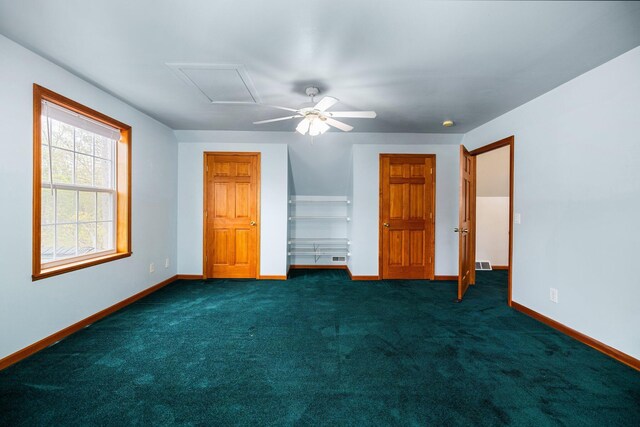 1350 Pine Point Dr, Lewiston, MI 49756 - unfurnished bedroom with baseboards, dark carpet, and ceiling fan