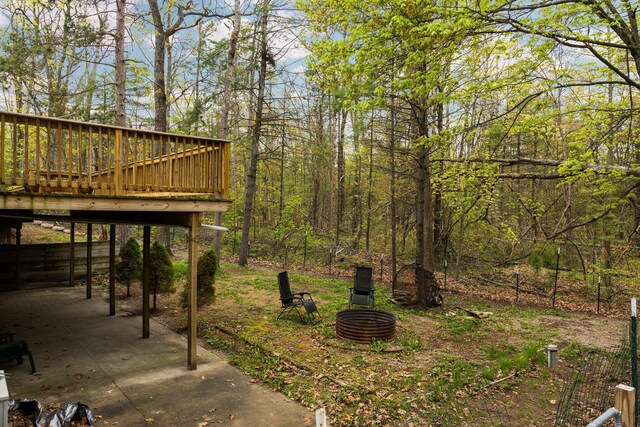 1350 Pine Point Dr, Lewiston, MI 49756 - view of yard featuring a deck, an outdoor fire pit, and a patio area