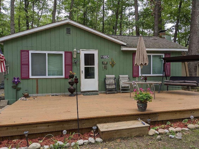 11052 W Higgins Lake Dr, Roscommon, MI 48653 - rear view of house with roof with shingles and a wooden deck