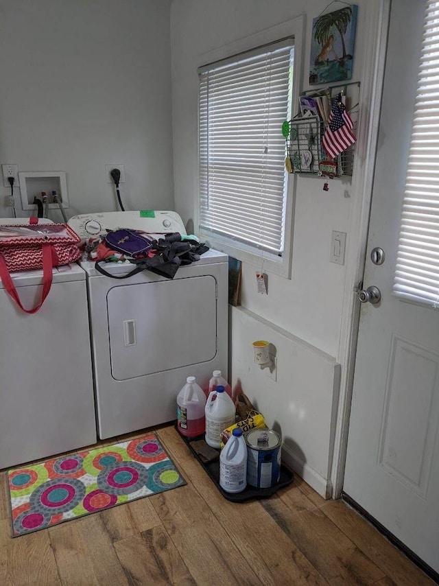 11052 W Higgins Lake Dr, Roscommon, MI 48653 - washroom with laundry area, washer and clothes dryer, and wood finished floors