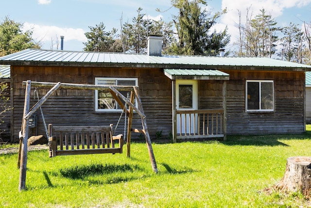 4441 Judy Ave, Lewiston, MI 49756 - rear view of property with a lawn, a chimney, and metal roof