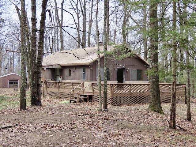 exterior space with board and batten siding and a deck