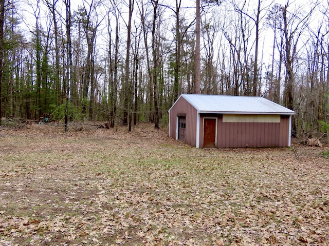 view of pole building featuring a forest view