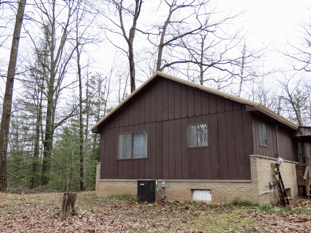 view of home's exterior with brick siding and central AC