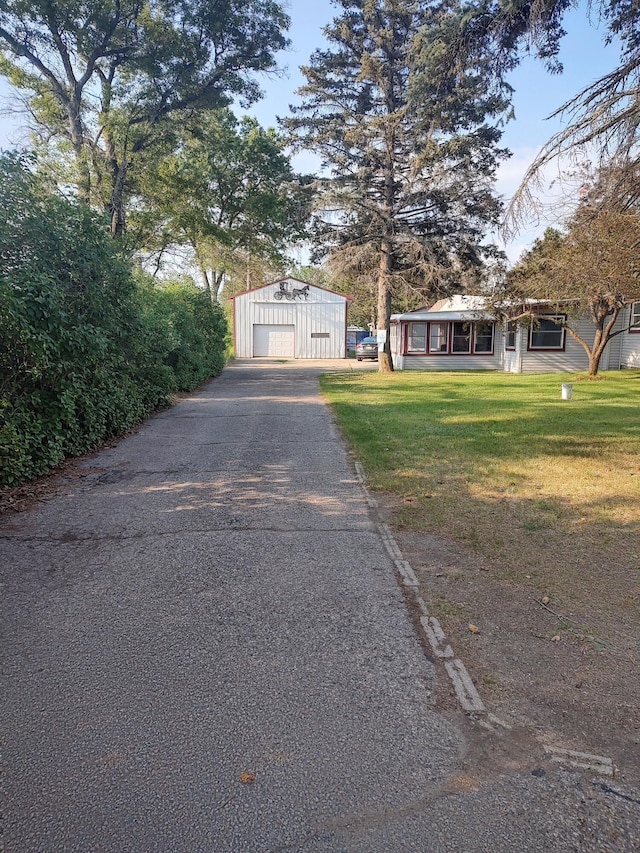 10232 E Airport Rd, Saint Helen, MI 48656 - view of front of property with a front lawn, aphalt driveway, an outbuilding, and a detached garage