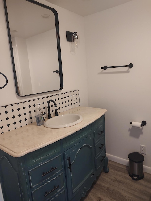 10232 E Airport Rd, Saint Helen, MI 48656 - bathroom featuring baseboards, tasteful backsplash, wood finished floors, and vanity