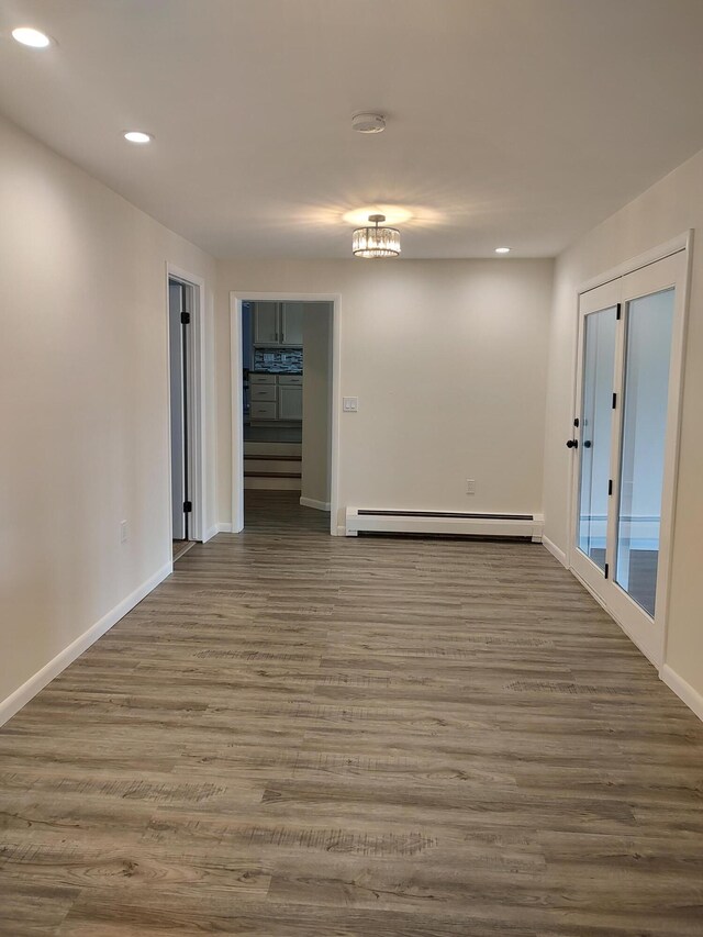 10232 E Airport Rd, Saint Helen, MI 48656 - unfurnished room featuring recessed lighting, wood finished floors, and a baseboard radiator