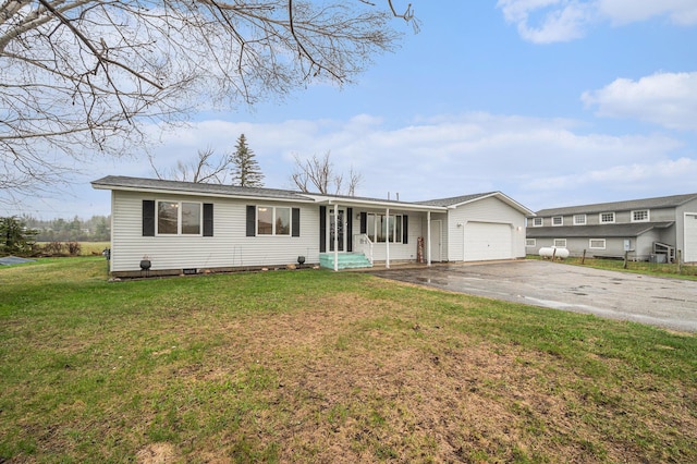 single story home featuring driveway, a front lawn, and a garage