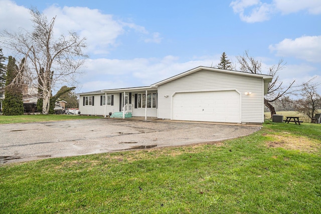ranch-style house with an attached garage, driveway, and a front yard