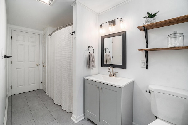bathroom with visible vents, vanity, baseboards, tile patterned floors, and toilet
