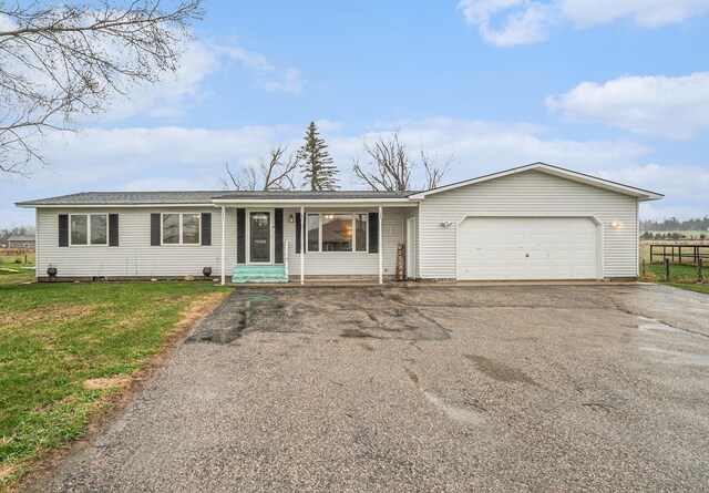 10524 Moonlight Bay Rd, Cheboygan, MI 49721 - ranch-style house with a garage, a front lawn, fence, entry steps, and driveway