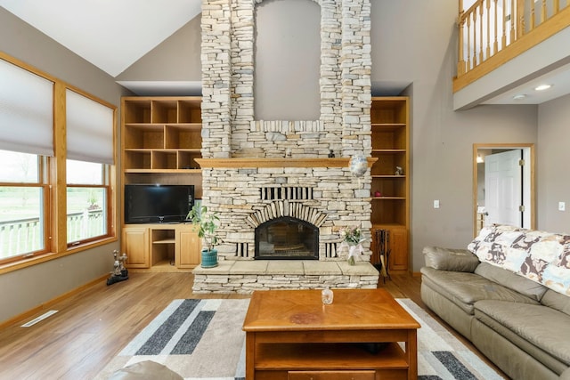 2211 N Kerby Rd, Owosso, MI 48867 - living room with wood finished floors, a fireplace, baseboards, and high vaulted ceiling