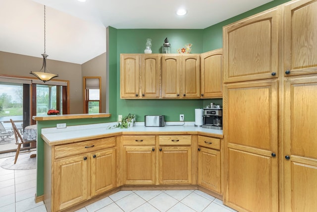 2211 N Kerby Rd, Owosso, MI 48867 - kitchen featuring lofted ceiling, light countertops, light tile patterned flooring, decorative light fixtures, and recessed lighting