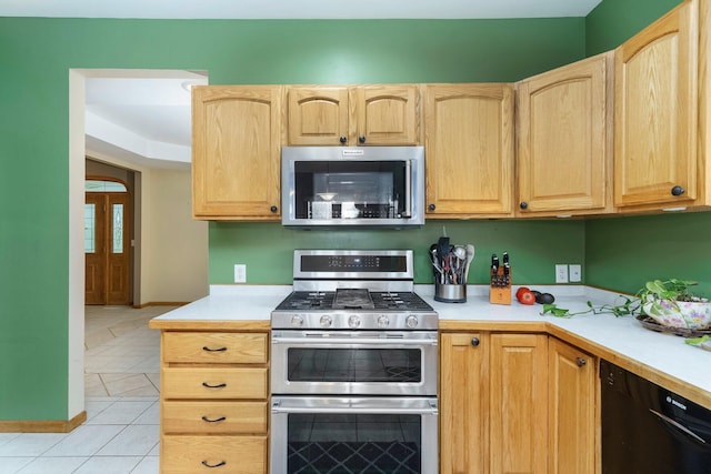 2211 N Kerby Rd, Owosso, MI 48867 - kitchen with appliances with stainless steel finishes, light brown cabinets, light countertops, and light tile patterned floors