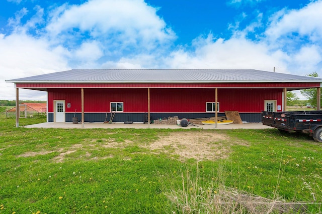 2211 N Kerby Rd, Owosso, MI 48867 - rear view of property featuring a pole building, an outbuilding, and metal roof